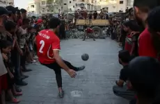 شباب ينطمون مباراة كرة قدم رغم الحرب.webp