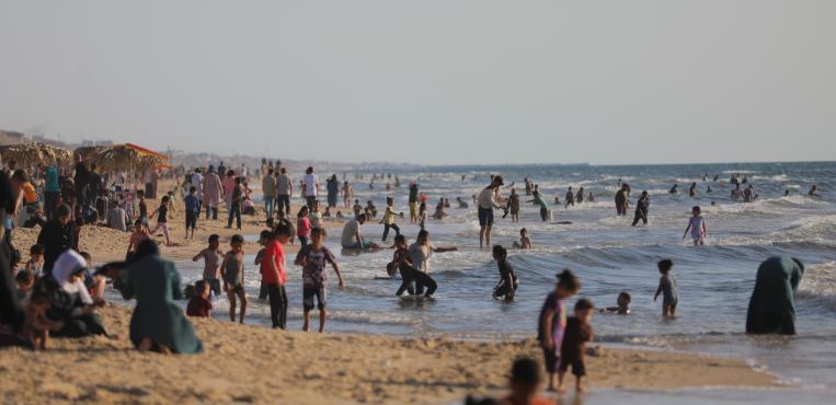 فلسطينيون يستجمّون على شاطئ بحر مدينة غزة هرباً من ضغوط الحرب والأوضاع الإنسانية الصعبة،